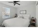Bright bedroom featuring a ceiling fan, window with blinds, and stylish decor at 10252 N 46Th Dr, Glendale, AZ 85302