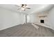 Spacious bedroom with gray carpet, brick fireplace, multiple closets, and ample natural light at 10252 N 46Th Dr, Glendale, AZ 85302
