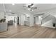 Spacious living area with wood floors, modern lighting, and open layout connecting to the kitchen at 10252 N 46Th Dr, Glendale, AZ 85302