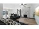 Cozy living area features a stone fireplace, wood floors, and comfortable seating, with dining in background at 10252 N 46Th Dr, Glendale, AZ 85302