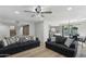Inviting living room with wood floors, ceiling fan, comfortable seating, and view to the kitchen/dining area at 10252 N 46Th Dr, Glendale, AZ 85302