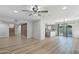 Bright living room boasts hardwood floors, modern fixtures, and an open concept to the kitchen at 10252 N 46Th Dr, Glendale, AZ 85302