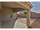 A covered back patio and desert landscaping surrounded by a block wall at 10353 W Atlantis Way, Tolleson, AZ 85353