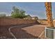 Backyard featuring a desert landscape, block wall, and view of neighboring houses at 10353 W Atlantis Way, Tolleson, AZ 85353