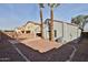 Back of the house with desert landscaping featuring two tall palm trees at 10353 W Atlantis Way, Tolleson, AZ 85353