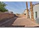 Gravel backyard area with privacy wall and two palm trees in residential neighborhood at 10353 W Atlantis Way, Tolleson, AZ 85353