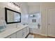 Elegant bathroom with a large mirror, soaking tub, and stylish vanity at 10353 W Atlantis Way, Tolleson, AZ 85353