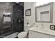 Modern bathroom featuring a luxurious shower with black tile, sleek fixtures, and a stylish vanity at 10353 W Atlantis Way, Tolleson, AZ 85353