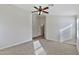 Neutral bedroom with a ceiling fan, carpeted floor, and doorway to other areas at 10353 W Atlantis Way, Tolleson, AZ 85353