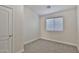 Empty bedroom with neutral carpet, a window with blinds, and a closet at 10353 W Atlantis Way, Tolleson, AZ 85353