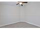 A bright bedroom features a ceiling fan, neutral walls, and carpet flooring at 10353 W Atlantis Way, Tolleson, AZ 85353