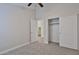 A cozy bedroom features a ceiling fan, neutral walls, carpet flooring, and closet at 10353 W Atlantis Way, Tolleson, AZ 85353