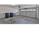 Spacious garage with concrete floor and white door; ready for parking and storage at 10353 W Atlantis Way, Tolleson, AZ 85353