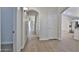Long hallway with wood-look flooring and white doors at 10353 W Atlantis Way, Tolleson, AZ 85353