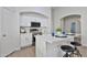 Modern kitchen featuring white cabinets, stainless steel appliances, and a breakfast bar at 10353 W Atlantis Way, Tolleson, AZ 85353
