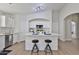 Bright kitchen features white cabinets, stainless steel appliances, and a large island with seating at 10353 W Atlantis Way, Tolleson, AZ 85353