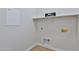 Bright laundry room with white walls, shelving, and connections ready for appliances at 10353 W Atlantis Way, Tolleson, AZ 85353