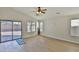 Bright living room features wood-look flooring, sliding doors to patio, and large windows at 10353 W Atlantis Way, Tolleson, AZ 85353