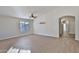 Bright, open living room with wood-look tile flooring and arched entryway at 10353 W Atlantis Way, Tolleson, AZ 85353