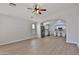 Bright, open living space with wood-look tile flooring, seamlessly flowing into the kitchen at 10353 W Atlantis Way, Tolleson, AZ 85353