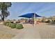 Neighborhood playground with covered play structure, slides, and landscaped surroundings at 10353 W Atlantis Way, Tolleson, AZ 85353