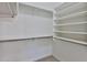 Spacious walk-in closet with built-in shelving and rods for optimal storage at 10353 W Atlantis Way, Tolleson, AZ 85353