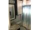 Cozy bathroom with blue striped shower curtain and white cabinets at 111 S Greenfield Rd # 426, Mesa, AZ 85206