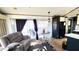 Comfortable living room that leads to a balcony with seating at 111 S Greenfield Rd # 426, Mesa, AZ 85206