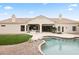 Backyard featuring a pool, patio area, artificial grass and a built-in barbecue at 11232 E Palomino Rd, Scottsdale, AZ 85259