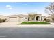 Charming home featuring a two-car garage, arched entryway, and well-maintained desert landscaping at 11232 E Palomino Rd, Scottsdale, AZ 85259