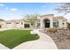 Stunning home featuring desert landscaping, a stone walkway, and mature trees in the front yard at 11232 E Palomino Rd, Scottsdale, AZ 85259