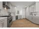 Bright kitchen featuring stainless steel appliances, gray cabinets, marble countertops, and wood flooring at 11232 E Palomino Rd, Scottsdale, AZ 85259