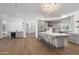 Wide angle of open concept kitchen with island seating and stainless steel appliances at 11232 E Palomino Rd, Scottsdale, AZ 85259