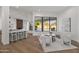 Bright and spacious living room with hardwood floors, modern furniture, and views of the pool at 11232 E Palomino Rd, Scottsdale, AZ 85259