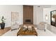 Bright living room features a fireplace, light hardwood floors, and modern furnishings at 11232 E Palomino Rd, Scottsdale, AZ 85259