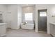 Bright bathroom with a modern soaking tub, sleek fixtures, and glass enclosed shower at 11232 E Palomino Rd, Scottsdale, AZ 85259