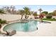 Beautiful pool featuring a rock waterfall, lush landscaping, and spacious patio area at 11232 E Palomino Rd, Scottsdale, AZ 85259