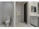 Bright bathroom featuring a toilet, towel rack and white cabinetry at 11357 E Unger Ave, Mesa, AZ 85212