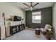 Cozy bedroom with a ceiling fan, dark accent wall, and modern decor offers a relaxing retreat at 11357 E Unger Ave, Mesa, AZ 85212