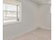 Bright bedroom featuring tile floors, neutral walls, and a window at 1149 E 5Th St, Casa Grande, AZ 85122