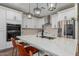 Beautiful kitchen with white cabinets, stainless steel appliances, a herringbone backsplash and a large center island at 11731 W Cabrillo Dr, Arizona City, AZ 85123