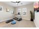 Bright gym featuring neutral tones, plantation shutters, and a treadmill perfect for getting exercise at 12365 E Gold Dust Ave, Scottsdale, AZ 85259