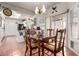 Charming dining area with wood table and seating next to kitchen with black appliances and lots of natural light at 13602 W Ballad Dr, Sun City West, AZ 85375