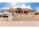 Charming single-story home featuring a tile roof, desert landscaping, and an American flag at 13602 W Ballad Dr, Sun City West, AZ 85375