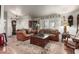 Inviting living room with comfortable leather seating, area rug, and ample natural light at 13602 W Ballad Dr, Sun City West, AZ 85375