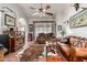 Another view of the living room showcasing a ceiling fan, leather furniture, and Southwestern-inspired decor at 13602 W Ballad Dr, Sun City West, AZ 85375