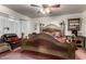 Spacious main bedroom featuring an ornate headboard, a cozy chair, and decorative accents for a unique style at 13602 W Ballad Dr, Sun City West, AZ 85375