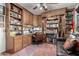 Well-appointed office with custom wood built-ins, desk, and shelving for an organized workspace at 13602 W Ballad Dr, Sun City West, AZ 85375