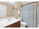 Bathroom featuring a single vanity, toilet, and shower/tub combination with a striped curtain at 13641 W Solano Dr, Litchfield Park, AZ 85340