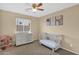 Well-lit Bedroom with neutral colors and large window at 13641 W Solano Dr, Litchfield Park, AZ 85340